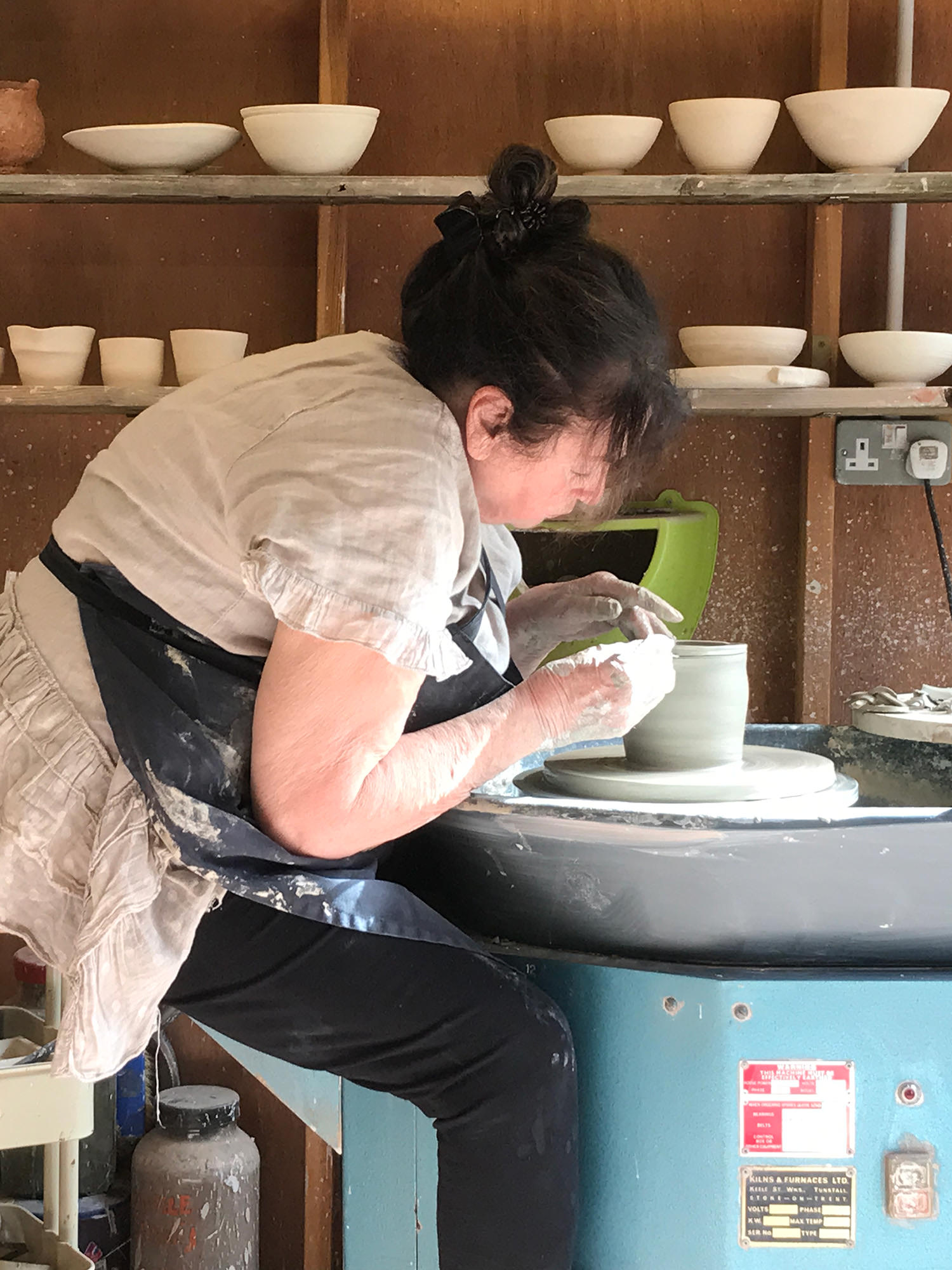 Susie Cousins making pottery on a clay wheel